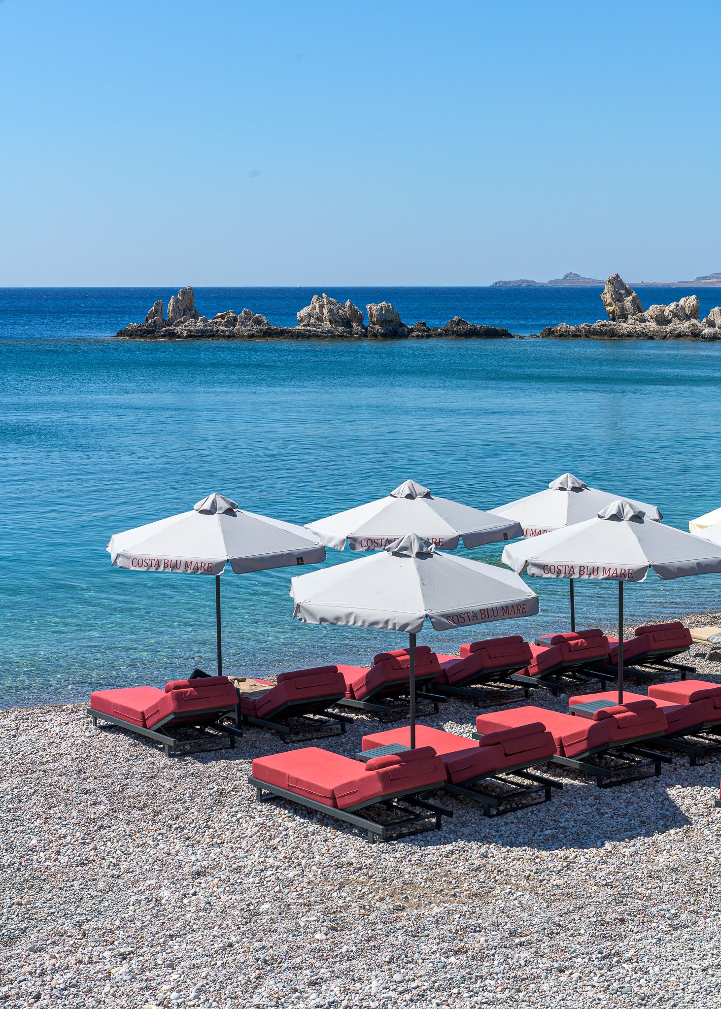 Sunbeds on Haraki beach, Costa Blu Mare